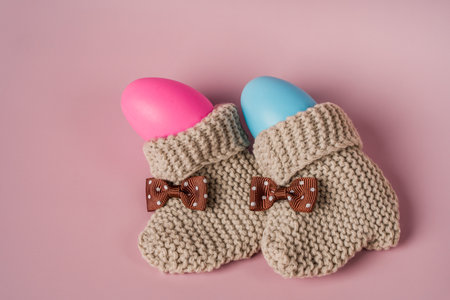 Baby booties and eggs in pink and blue. Definition of the child's gender, the expectation of a child, the concept of pregnancyの写真素材