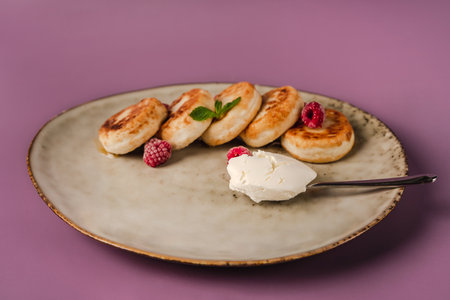 Healthy breakfast, cheese pancakes with raspberry and mint, copy spaceの写真素材