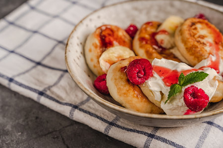 Healthy breakfast, cheese pancakes with raspberry and mint, copy spaceの写真素材