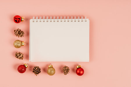 Christmas background with blank white notebook surrounded by Christmas decorations. Letter to Santa or Christmas shopping list. Top view, copy spaceの写真素材