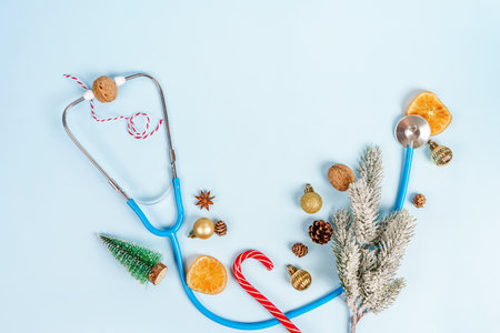 Christmas medical composition on a blue background with Christmas toys and a stethoscope. Place for textの写真素材