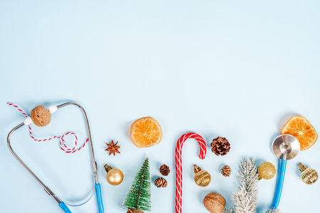 Christmas medical composition on a blue background with Christmas toys and a stethoscope. Place for textの写真素材