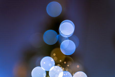 Blurry bokeh light from Christmas tree garland. Defocused abstract Christmas lightの写真素材