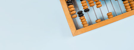 Wooden old abacus on a blue background. Flat lay and top view. Business or accounting conceptの写真素材