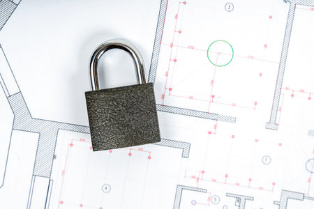 Metal lock from the new house on the design drawing of the apartment plan. Real estate sales and symbolsの写真素材