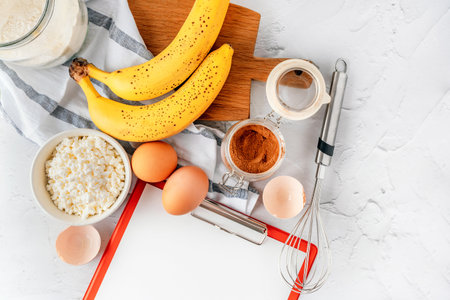 Various ingredients for baking with banana and cinnamon on a gray background. Copy space, top view.の写真素材