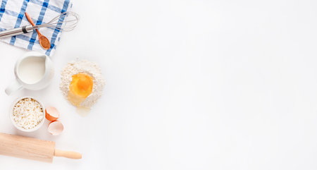 Baking homemade sweets on white table with ingredients for cooking, culinary background, copy space, overhead viewの写真素材