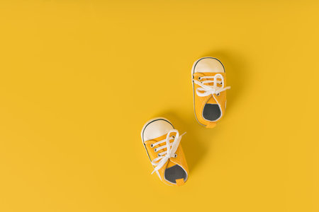Baby's little sneakers on a colorful background. The concept of waiting for a baby and the concept...