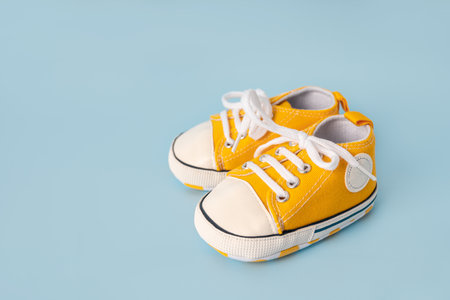 Baby's little sneakers on a colorful background. The concept of waiting for a baby and the concept...
