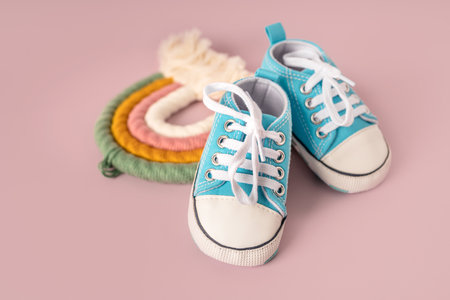 Baby's little sneakers on a colorful background. The concept of waiting for a baby and the concept of traveling with baby, children's lifestyle. Copy space, flat layの写真素材