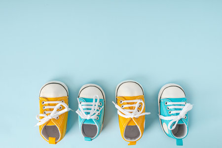 Baby's little sneakers on a colorful background. The concept of waiting for a baby and the concept...