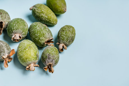 Feijoas lie on a blue isolated backgroundの写真素材