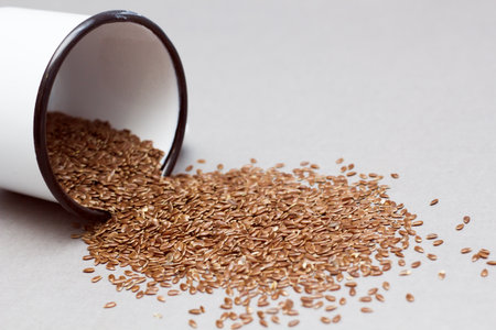 Organic food concept with flax seeds on a gray background, close upの写真素材