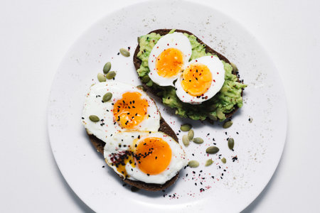 sandwich with fresh vegetables, avocado, hard-boiled eggs and pumpkin seeds with olive oil and...
