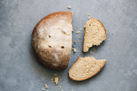 warm, freshly rye bread. Cut the slices. Tear off a piece. top view. Farm food made from flour and eggs.の写真素材