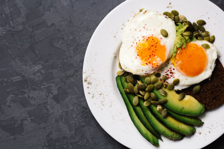 sandwich with fresh vegetables, avocado, hard-boiled eggs and pumpkin seeds with olive oil and bread. healthy diet or vegetarian food on a white background. salad with yolks on toast. top viewの写真素材