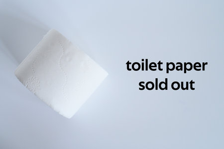 rolled white toilet paper on a white background and text toilet paper sold out. ofl font. flat lay, top viewの写真素材