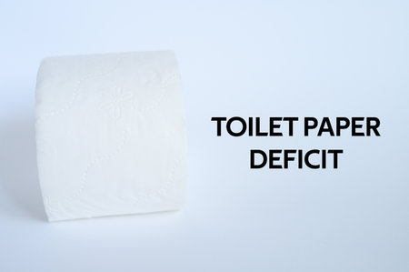 rolled white toilet paper on a white background and text toilet paper deficit. ofl fontの写真素材