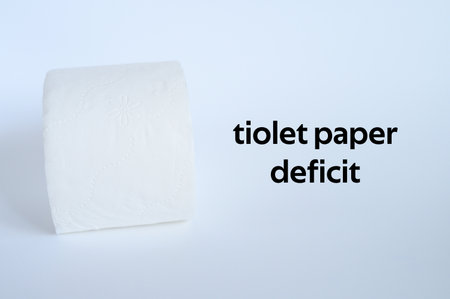 rolled white toilet paper on a white background and text toilet paper deficit. ofl fontの写真素材