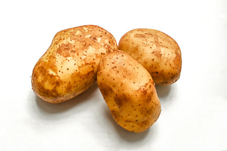 young potatoes with hard shadows on a white backgroundの写真素材