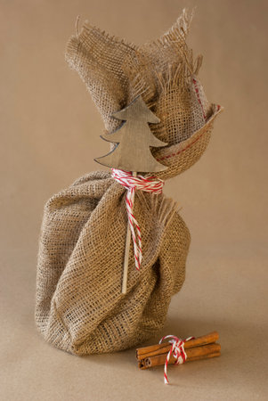 Beautiful handmade Christmas gift, packaging with rustic decorative sackの写真素材