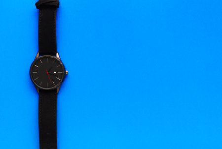 International Fathers Day. Mens holiday. Greeting card for dad. Wristwatch on a blue background. Mens Accessories. Place for text. Flat lay. Top view.の写真素材