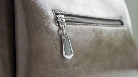 Metal lock on the bag. Small pocket. Castle close-up. Small womens bag. Gray summer bag. Accessory of the female image.の写真素材