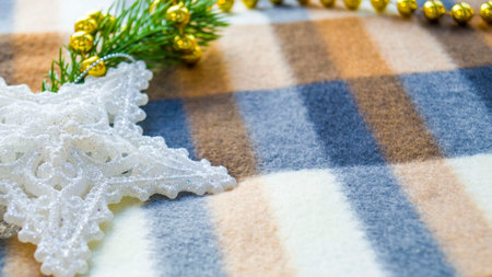 New Year and Christmas card. Christmas decorations on a blanket. A spruce branch, a white star and...