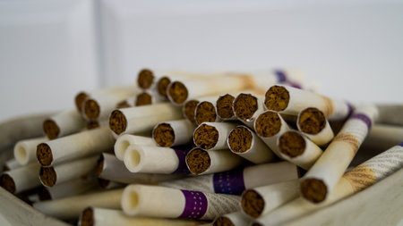 A bunch of sticks for the tobacco heating system on a light background. Used sticks in the ashtray. It does not burn tobacco, but heats it up. Technologies in the modern world of smoking.の写真素材