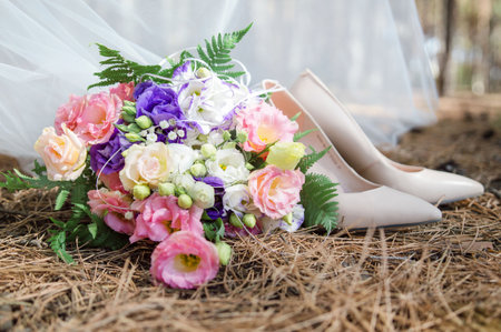 bridal bouquet on the ground and high heelsの写真素材