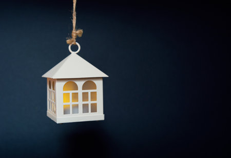 toy house with light in the window on a black backgroundの写真素材