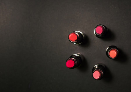 bright varied color palette of lipsticks on a black background. lipstick advertising. for a blog about cosmetics. The beauty. Colored cosmetic pigmentsの写真素材