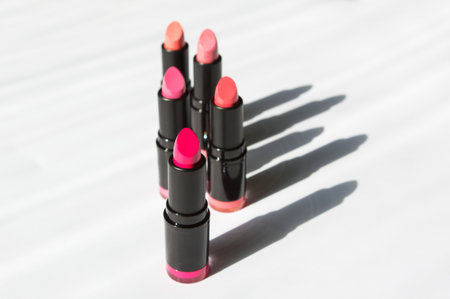 Lipstick in bright colors. varied lipsticks of a pink shade on a white background. lipstick shadow. photo above. lipstick advertising, for a lipstick blogの写真素材