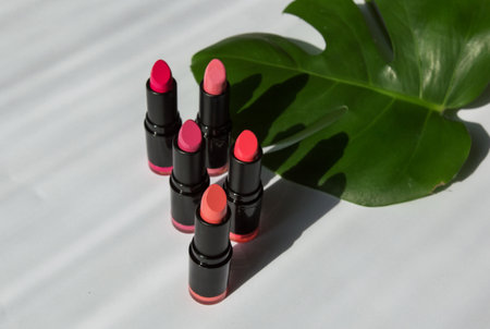 Lipstick in bright colors. varied lipsticks of a pink shade on a white background. lipstick shadow. photo above. lipstick advertising, for a lipstick blogの写真素材