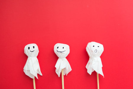 Halloween flat lay - bats and glitches on red background. gifts and shopping for halloween. place for text. holidays and surprises.の写真素材