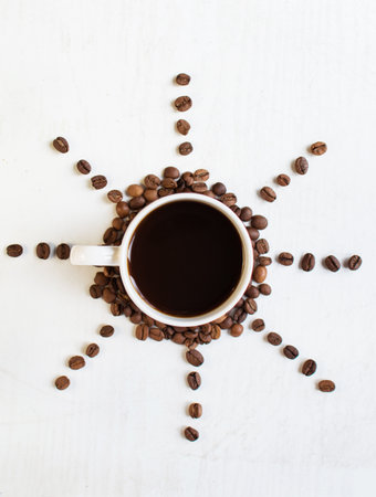 sun from coffee beans on a white background. Coffee time. kind of sveru. flat lay. space for...
