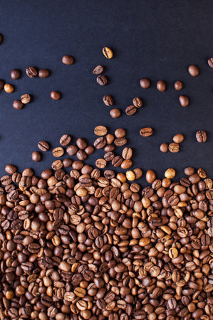 roasted aromatic coffee beans on a dark background. coffee background. flat lay with place for text. view from above.の写真素材