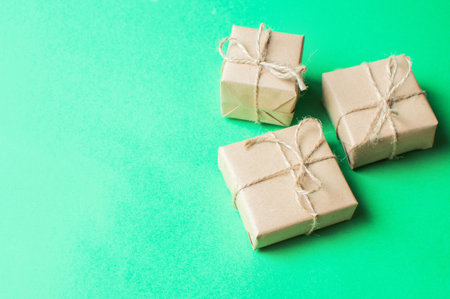 Festive concept - a gift with a bow and cones on a green and red background. composition for...