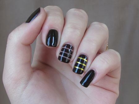 brown manicure with gold ribbonsの写真素材