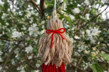 Handmade doll knitted from a red threads. Back view. Macrame technique. Eco decoration for the interior in boho style.の写真素材