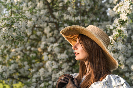 Portrait of attractive caucasian woman in retro straw hat and vintage black lace gloves. Side view....