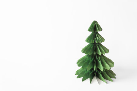 Handmade foldable Christmas tree from plastic free material - green paper isolated on white background. DIY concept.の写真素材