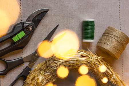 Set of professional florist tools: pruner, sciccors, spool of thread and wire, straw wreath base....