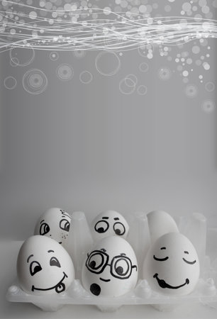 Eggs with cheerful faces are vertical. A photo with a place under the text for your desの写真素材