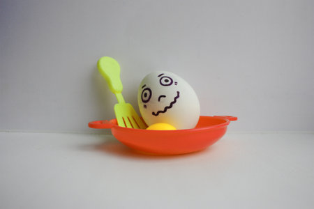Eggs with face. Concept of nervous tremorの写真素材