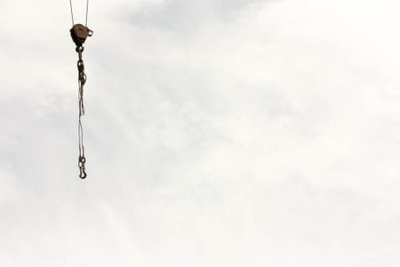 A hook of a construction crane against the sky and clouds. Photo for your design.の写真素材
