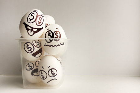 The concept of profit and business ideas in the head of doubt and decision. Eggs with eyes in...