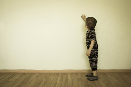 Concept of creativity. The child at the wall writes. Photo for your design. With a place under the text.の写真素材