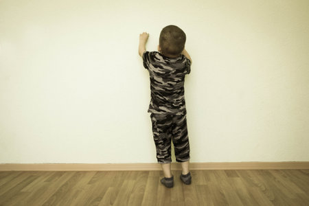 Concept of creativity. The child is at the wall. Photo for your design. With a place under the text.の写真素材