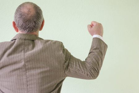 Business concept of strength and success. A man holding a fist. Photo for your designの写真素材